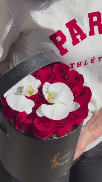 Red Roses with Orchid Flowers in Medium Black Box